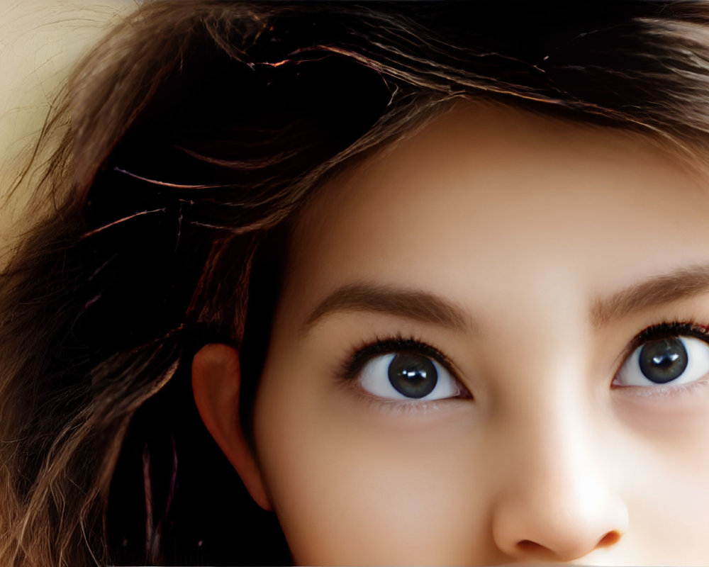 Detailed portrait of person with expressive brown eyes and fine hair strands on warm backdrop