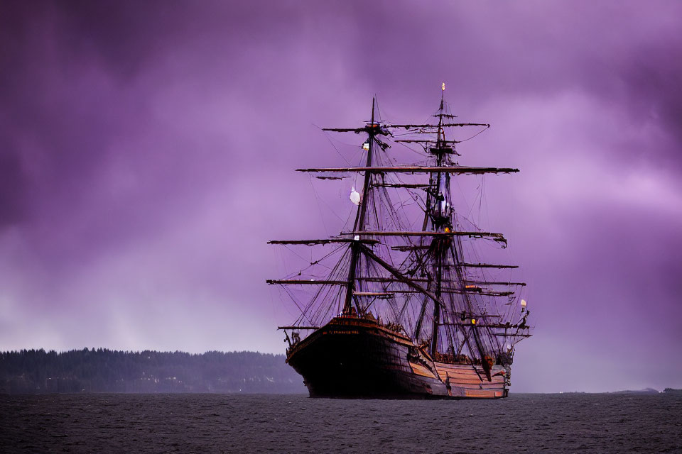 Tall ship with multiple masts on calm water under purple sky