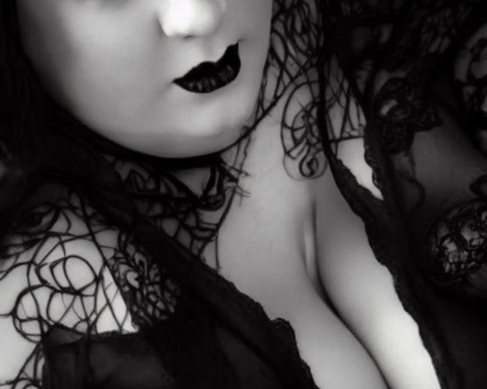 Monochrome portrait of person in dark makeup and lace attire.