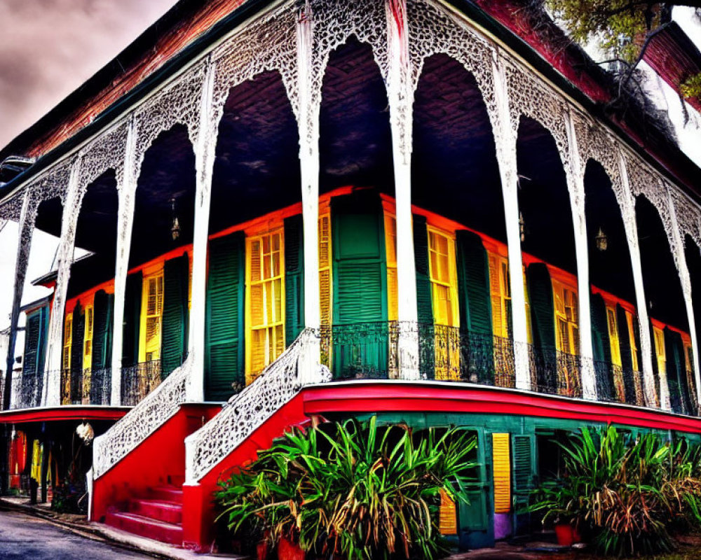 Colorful building with ornate balconies, red stairs, and greenery.