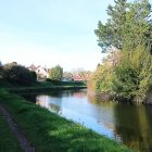 Tranquil river in lush landscape with green trees and hills