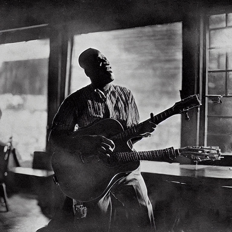 Vintage Black and White Photo of Person Playing Acoustic Guitar by Window