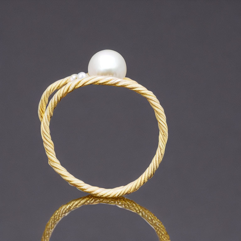 Twisted Gold & Silver Ring with Large Pearl on Dark Background