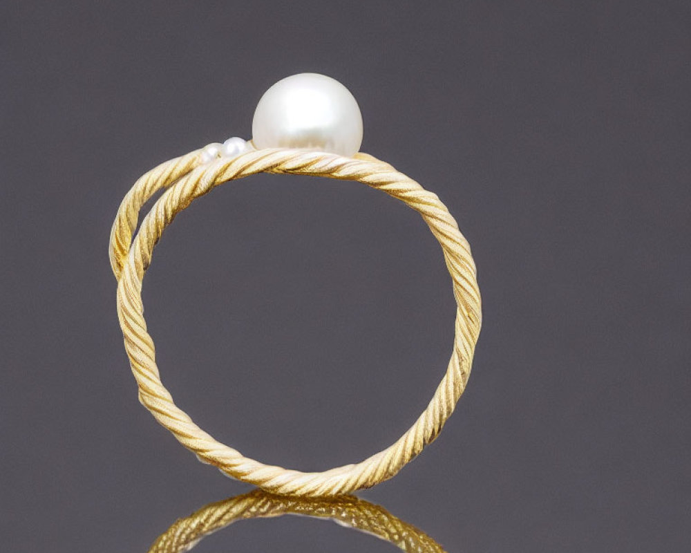 Twisted Gold & Silver Ring with Large Pearl on Dark Background