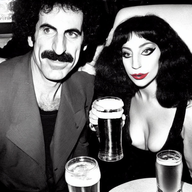 Monochrome image of man with mustache and woman with red lipstick at table with beer