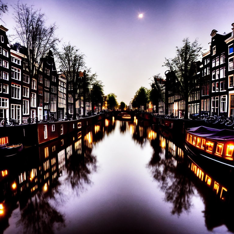 Amsterdam canal at twilight with illuminated windows, bicycles, and crescent moon