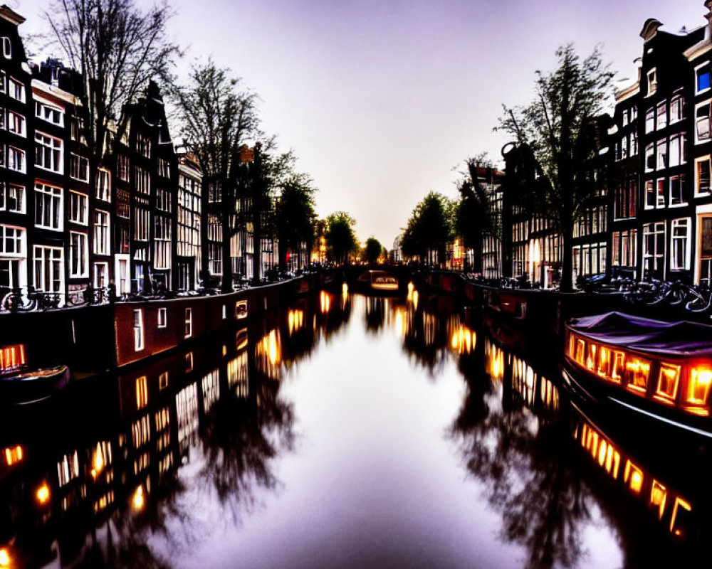 Amsterdam canal at twilight with illuminated windows, bicycles, and crescent moon