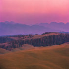 Scenic landscape of tree-dotted hills under a pinkish-purple sky
