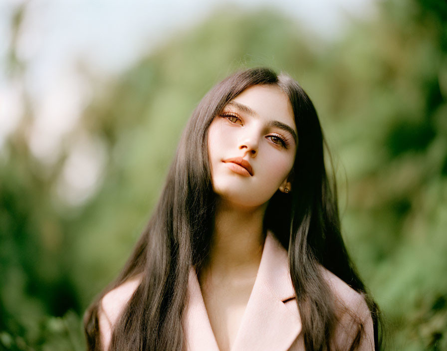 Portrait of Woman with Long Black Hair in Beige Blazer on Soft Green Background