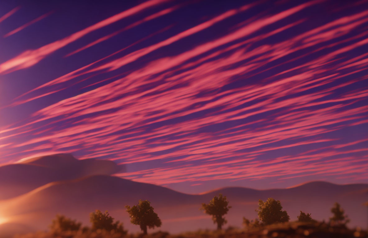 Twilight sky with pink and purple streaked clouds over mountains and trees