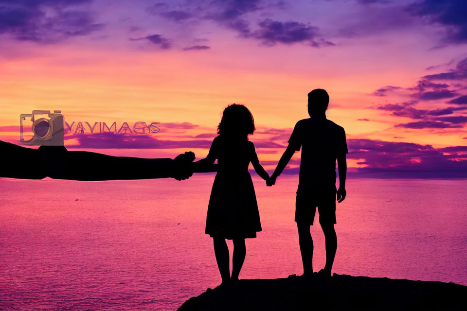 Couple holding hands in vibrant purple and orange sunset.