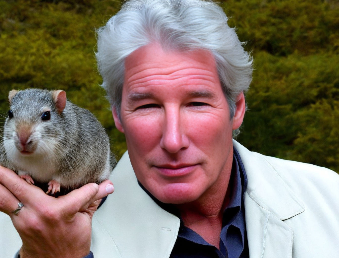 Elderly man with gray hair holding small rodent, green background