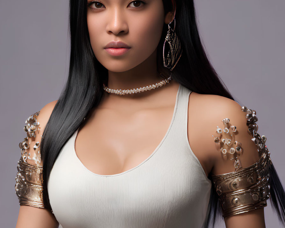 Long-haired woman in sleeveless top with ornate jewelry and metallic arm cuffs