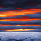 Vibrant sunset illuminating frozen landscape with ice and snow under dramatic sky