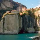 Futuristic building carved into mountain face over water