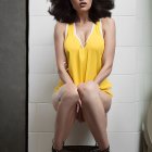 Woman in Retro Yellow Polka Dot Dress and Red Sunglasses on Toilet