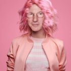 Person with Pink Hair in Pink Blazer on Pink Background