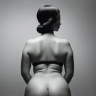 Monochrome image of woman with elegant updo and bare back