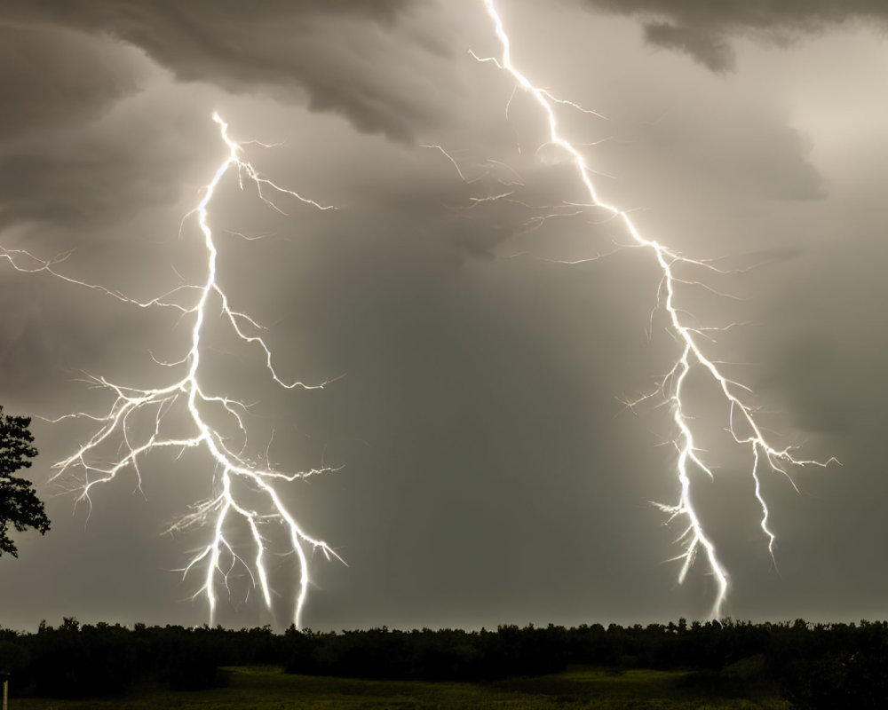 Nocturnal thunderstorm with two lightning strikes in cloudy sky