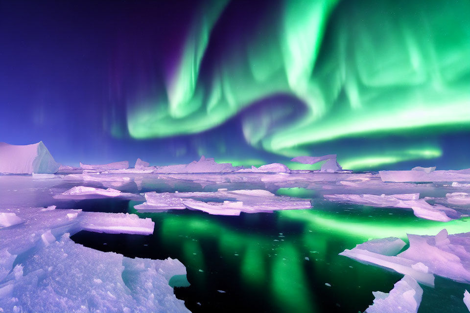 Spectacular green aurora borealis over icy landscape at night