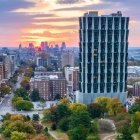 Abandoned high-rise building with decay and overgrown vegetation at sunset