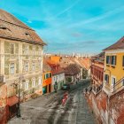Dilapidated urban scene with abandoned buildings and vehicles at twilight
