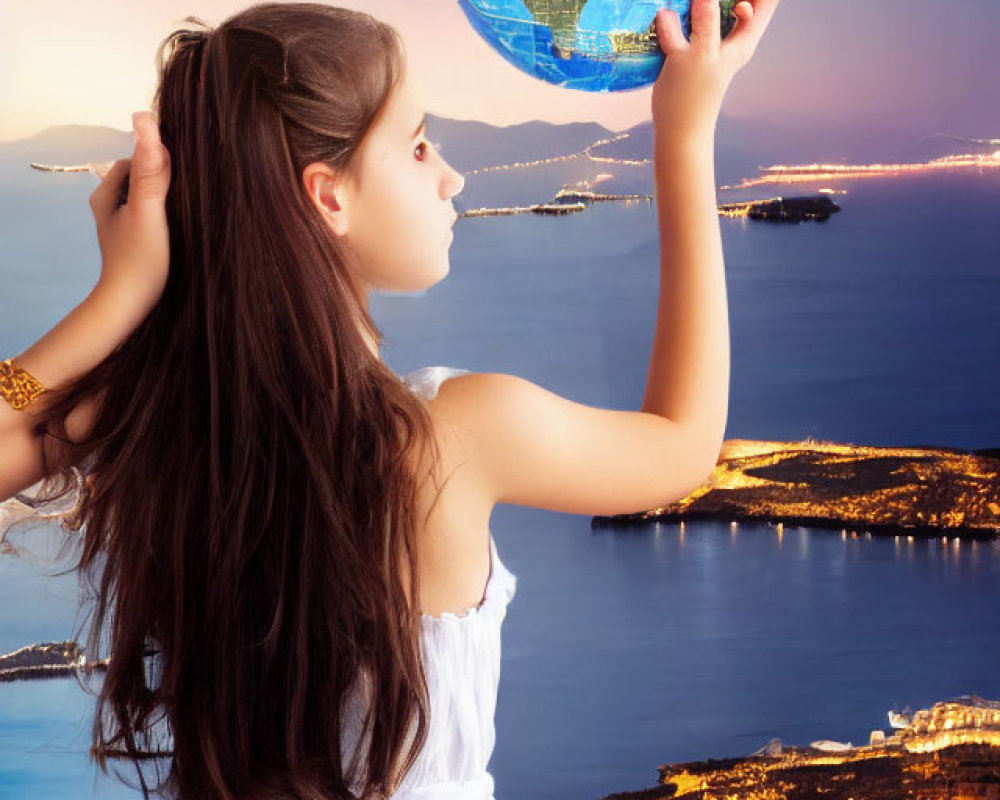 Young girl in white dress holds glowing globe above coastal cityscape at dusk