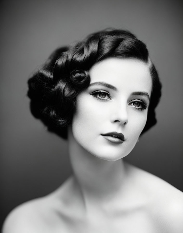 Monochrome portrait of woman with vintage hairstyle and bold makeup