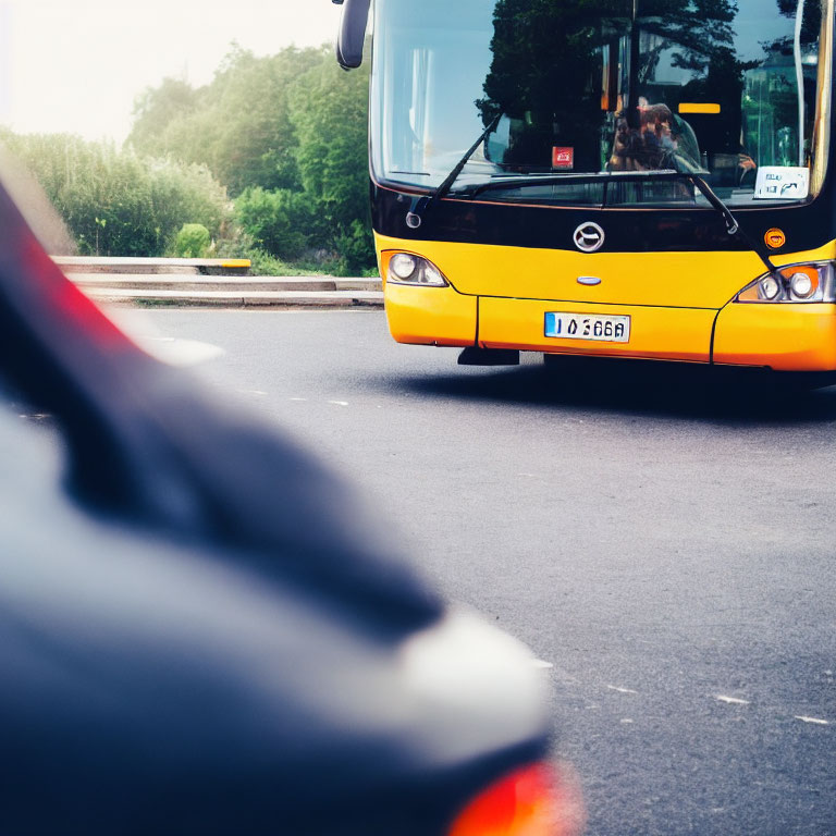 Yellow City Bus Partially Obscured by Blurred Car