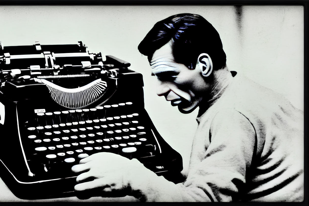 Monochrome image of surprised man at typewriter