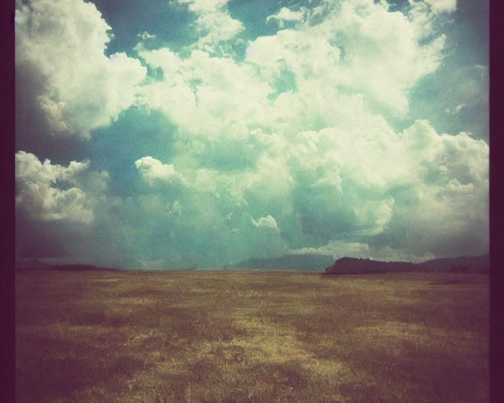 Tranquil field under dramatic sky with vintage sepia filter