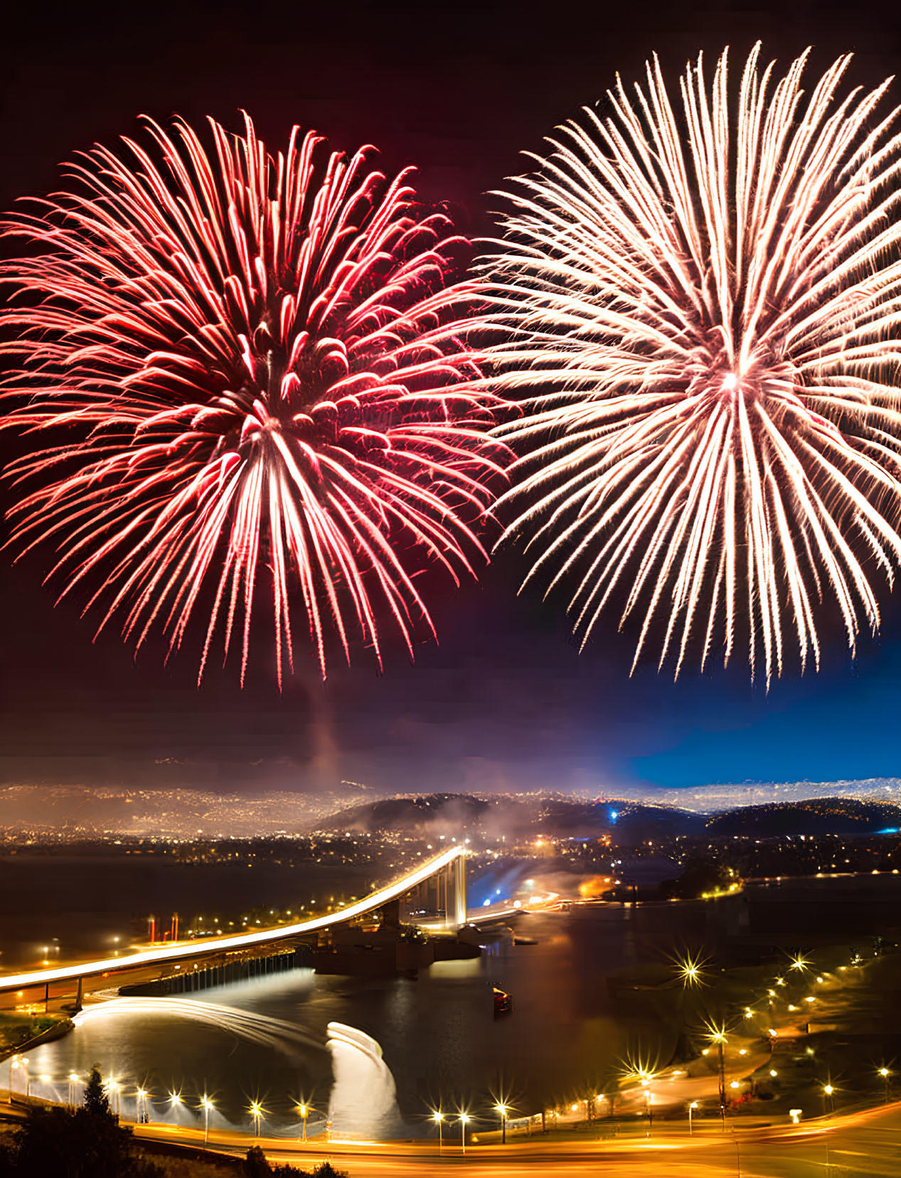 Vibrant fireworks illuminate night sky over river bridge