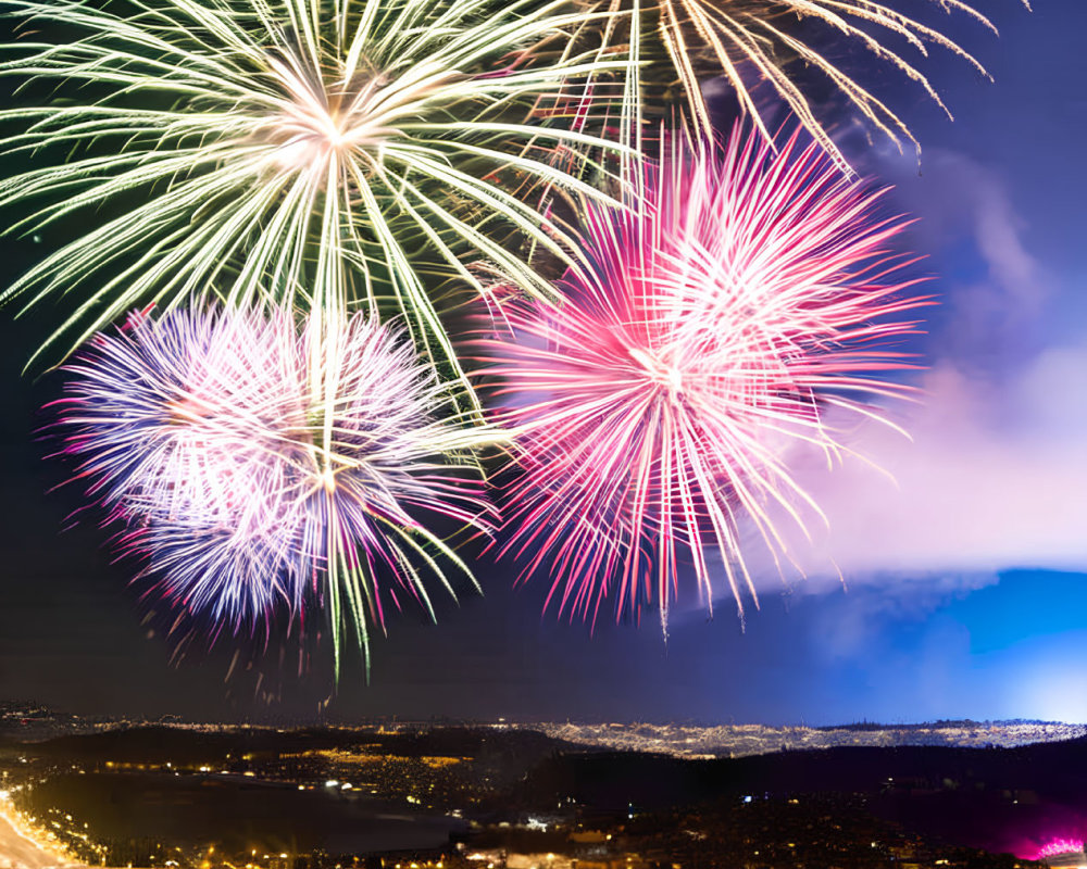 Colorful fireworks display over illuminated cityscape at night