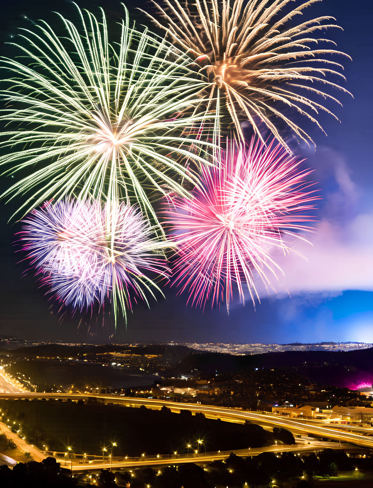 Colorful fireworks display over illuminated cityscape at night