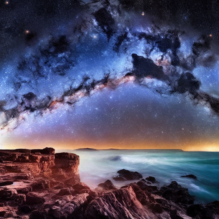 Nighttime Milky Way over rugged coastline with twilight glow