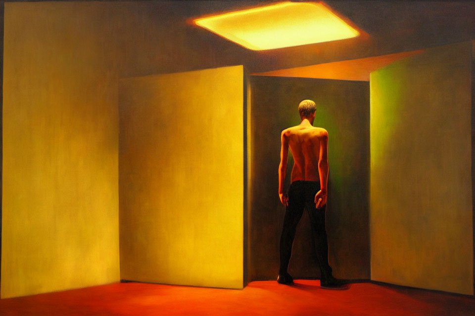 Shirtless man standing in yellow room with dramatic lighting