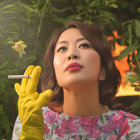 Woman in floral dress holding cigarette in natural setting