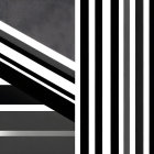 Contrast of textures in abstract image: gritty gray surface and black & white vertical stripes.