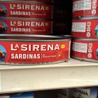 Various Canned Goods and Beverages on Wooden Pantry Shelves