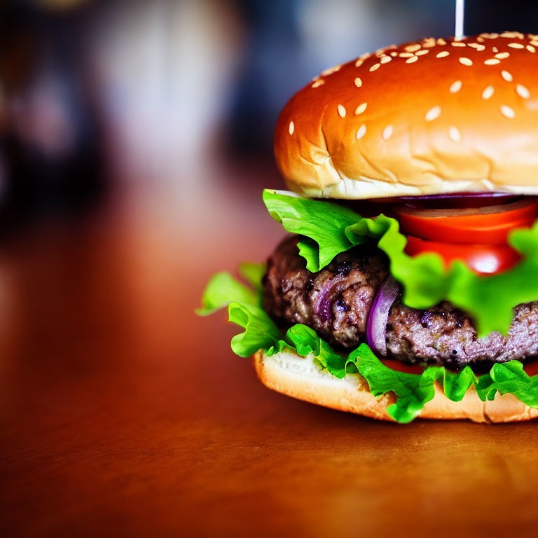 Sesame Seed Bun Burger with Lettuce, Tomato, and Onion on Wooden Surface