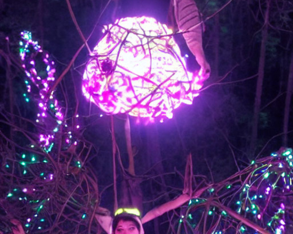 Woman illuminated in colorful lights with support below