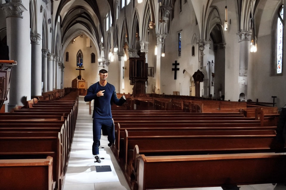 Person in casual attire wearing VR headset in bright church interior