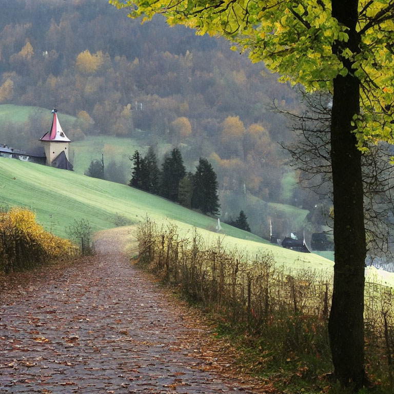 Cobblestone Path Through Autumn Landscape with Church and Hills