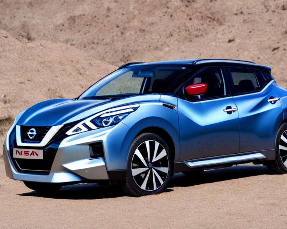 Blue Nissan SUV Parked on Sandy Terrain with Modern Alloy Wheels