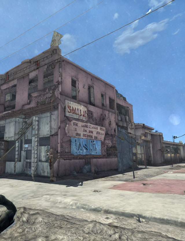 Abandoned two-story desert building with graffiti and boarded-up windows