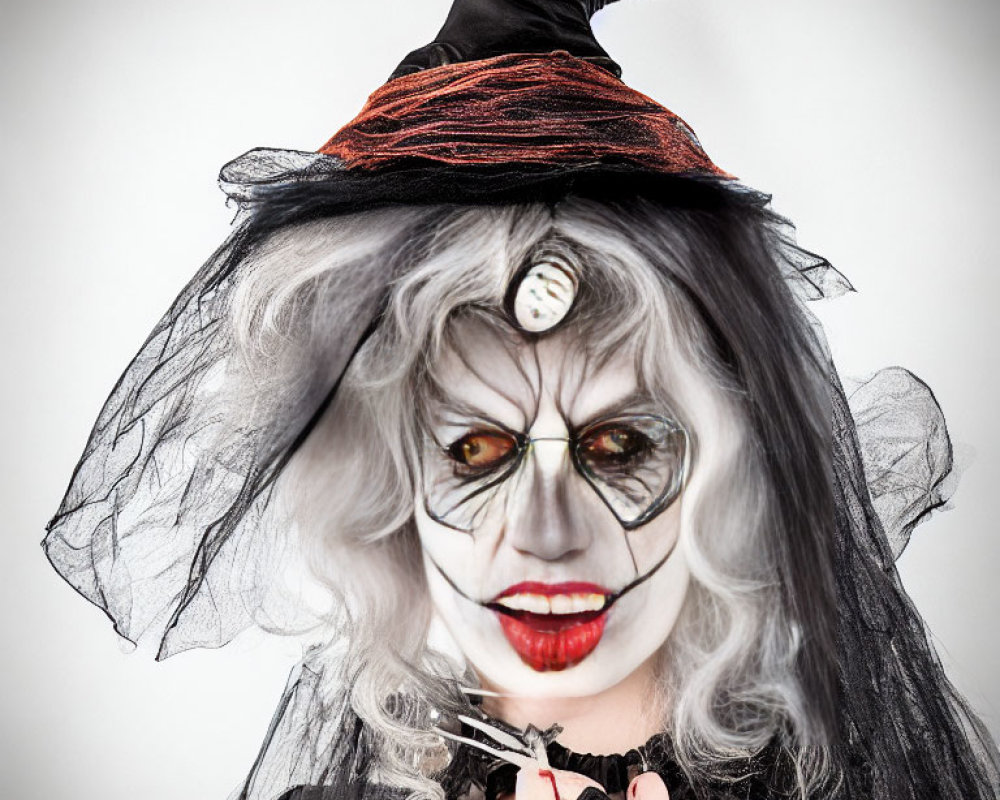 Person in witch makeup with black hat, veiled face, button eye, and scissors.