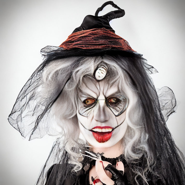 Person in witch makeup with black hat, veiled face, button eye, and scissors.