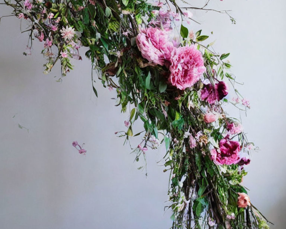 Pink peonies and delicate blooms in lush floral arrangement