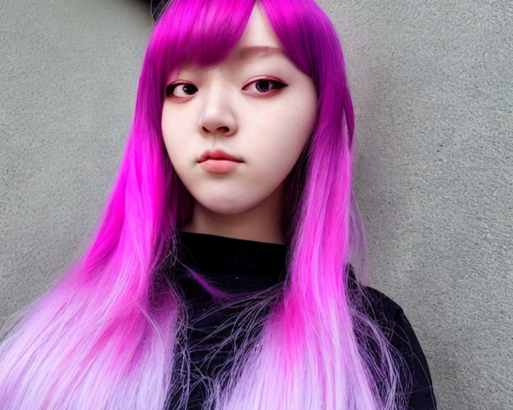 Striking purple hair and makeup against grey background.