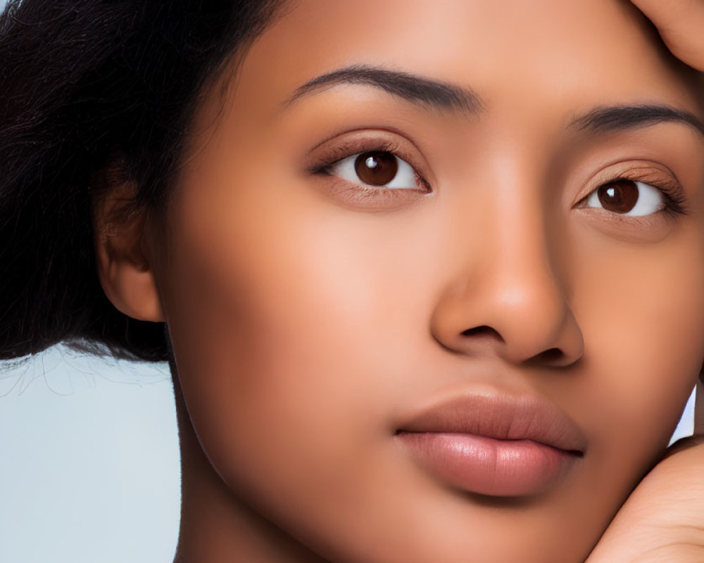 Serene woman portrait against light blue background